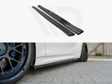 Black car side skirts are displayed above an image showing them installed on a white car parked on a brick driveway, with visible aftermarket wheels.