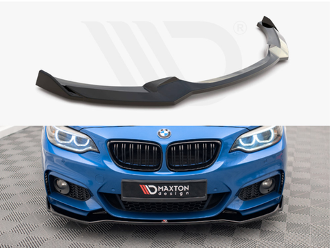 A black car front splitter rests on a white surface. Below, it is installed on a blue BMW, enhancing the sporty front design. The branded license plate reads "MAXTON design."