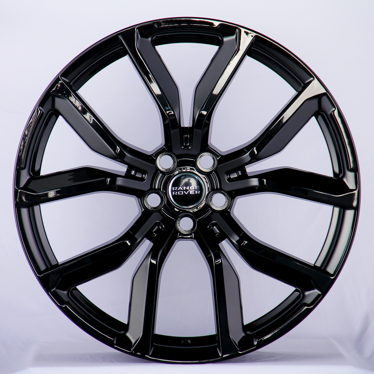 A glossy black alloy wheel with a five-double-spoke design, featuring the "Range Rover" logo at the center, displayed against a plain white background.