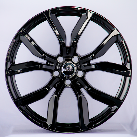 A glossy black alloy wheel with a five-double-spoke design, featuring the "Range Rover" logo at the center, displayed against a plain white background.