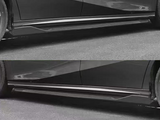 Car side skirts on a black vehicle in two images, emphasizing their sleek design, are set against an asphalt road. Both front and rear wheels are partially visible.