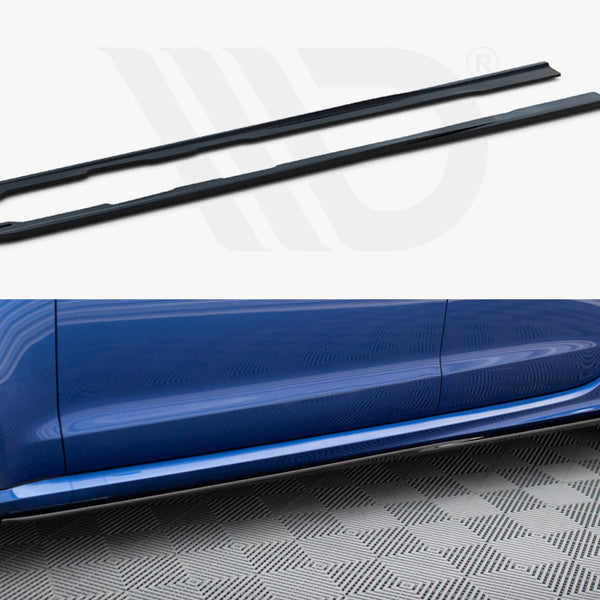 Two black side skirts sit above an image of a blue car's side with a fitted side skirt, on a textured gray floor.