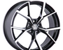 A black and silver alloy wheel with a geometric spoke design is displayed, featuring a central emblem with "VW." The wheel is positioned against a plain white background.