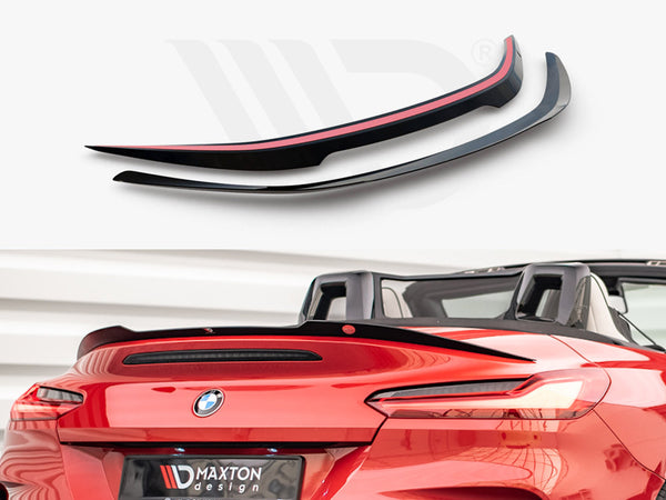 Two aerodynamic car spoilers are displayed above a red convertible, enhancing its sporty appearance. The background features a neutral setting. Text on the plate reads "MAXTON design."