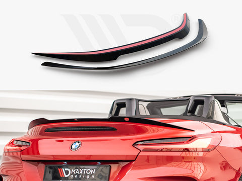 Two aerodynamic car spoilers are displayed above a red convertible, enhancing its sporty appearance. The background features a neutral setting. Text on the plate reads "MAXTON design."