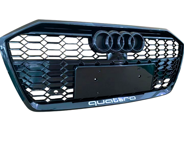 A black car grille displays three circular emblems at the top and “quattro” text at the bottom, featuring a honeycomb pattern.