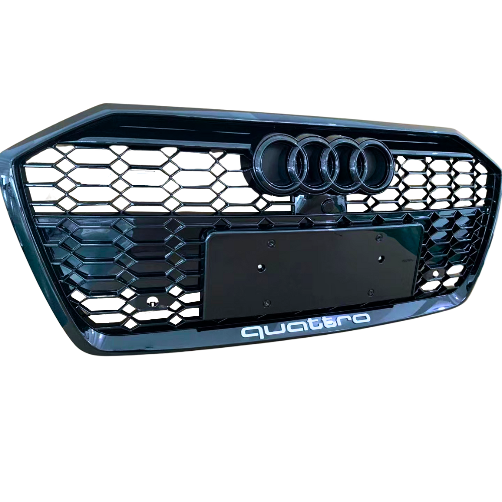 A black car grille displays three circular emblems at the top and “quattro” text at the bottom, featuring a honeycomb pattern.