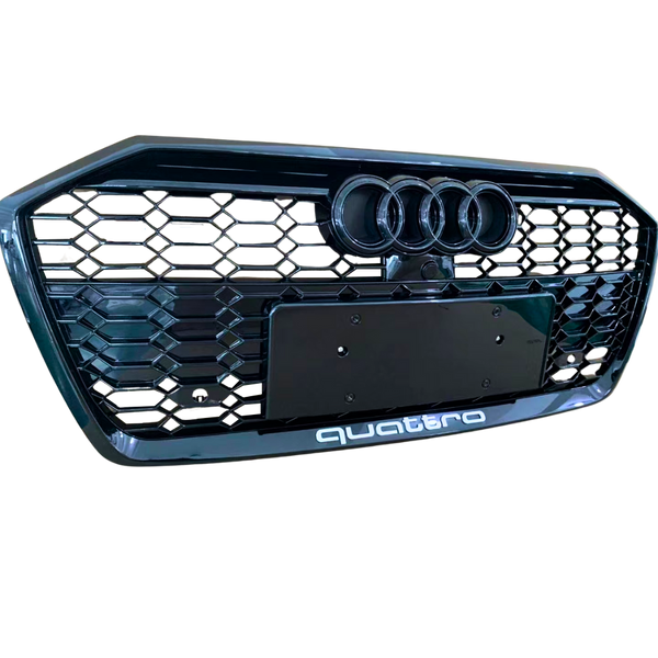 A black car grille displays three circular emblems at the top and “quattro” text at the bottom, featuring a honeycomb pattern.