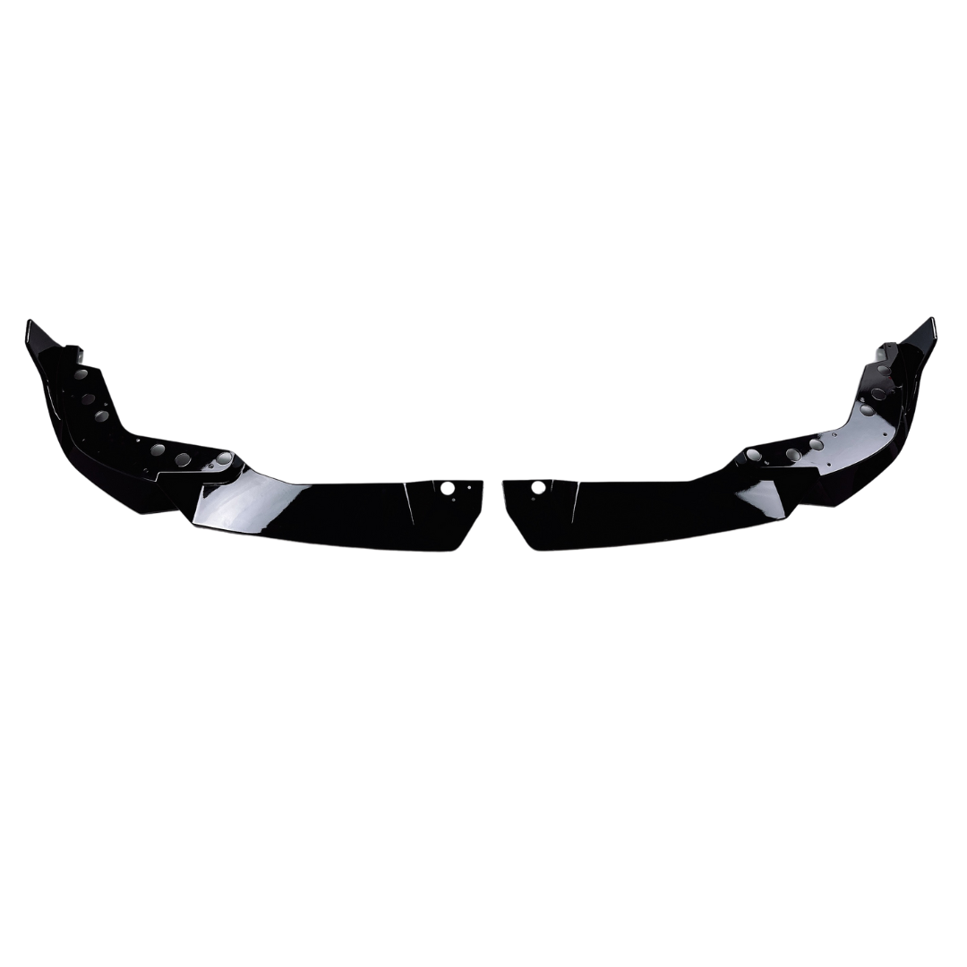 Two black, angular car splitters with mounting holes are displayed on a white background, positioned as mirror images, suggesting attachment beneath a vehicle's front bumper for aerodynamic purposes.