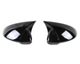 Two black, glossy side mirrors with aerodynamic design sit facing each other against a plain white background, reflecting light and showing smooth surface contours.