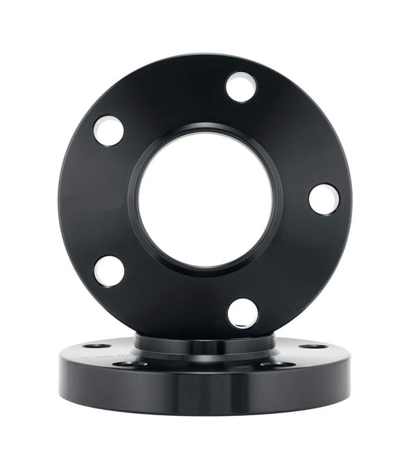 A black circular metal flange with five bolt holes is vertically positioned, placed on another similar flange beneath it against a plain white background.