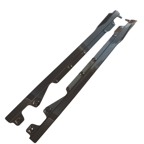 Two long, metallic bars with multiple bolt holes, oriented diagonally. The bars have a reflective surface and are set against a plain, white background.