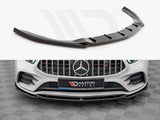 A black car front splitter is displayed; it enhances the aerodynamics of a white Mercedes-Benz with a prominent grille. A sign reads “Maxton design” on the bumper.