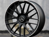 A black alloy wheel with Mercedes-Benz logo and 