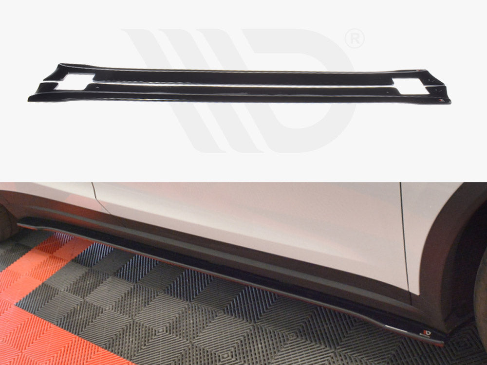 A black car side skirt lies on a textured floor, with a white vehicle parked nearby, partially showing the skirt attached. The background has a mix of red and gray patterns.