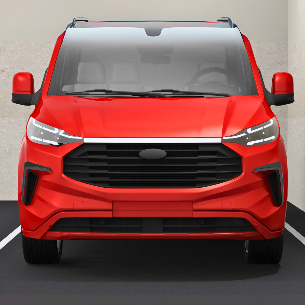 A red van is parked against a beige wall. It features a large black grille, sleek headlights, and visible side mirrors, emphasizing its modern design.