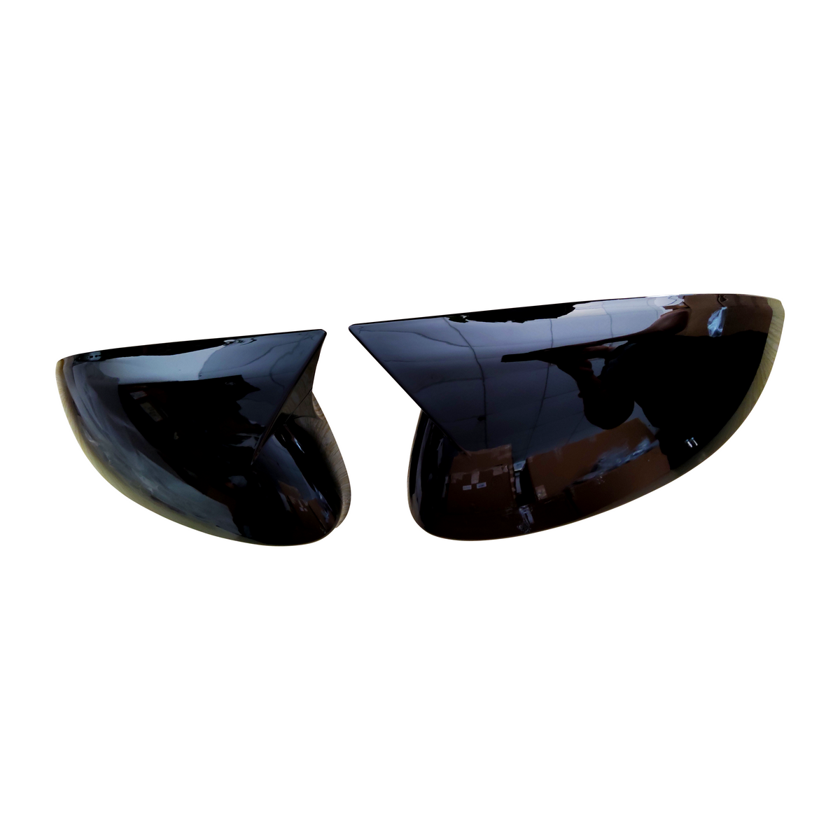 Two glossy black half-sphere objects, resembling car side mirrors, are positioned facing each other against a plain white background.