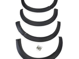 Four black plastic fender flares arranged vertically, each slightly curved, with a small bag of screws below, placed against a plain white background.