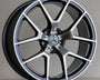 A silver and black Mercedes-Benz AMG alloy wheel rests upright against a neutral background, featuring a five-twin-spoke design and prominent Mercedes emblem at the center.