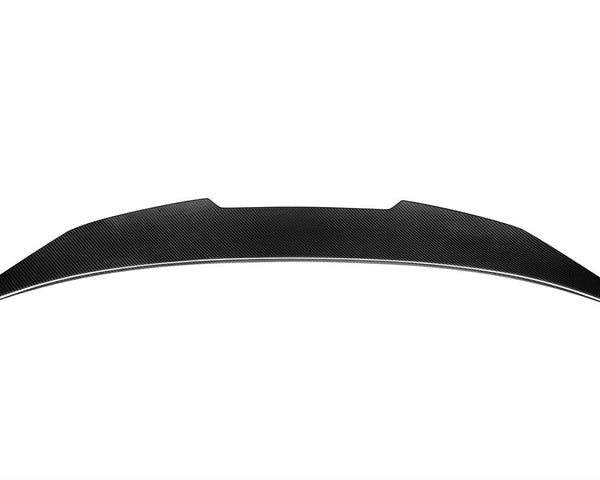 A sleek, black carbon fiber car spoiler rests on a plain white background, showcasing a smooth, aerodynamic curve with tapered ends.