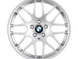 A silver alloy wheel with a BMW logo at the center, displaying multiple spokes, set against a plain white background.