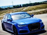 A blue Audi station wagon, parked on a road, features black wheels and a 