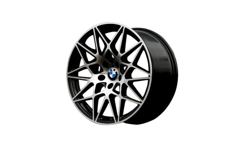A black alloy wheel with intricate interwoven spokes, featuring a central BMW logo, displayed on a plain white background.