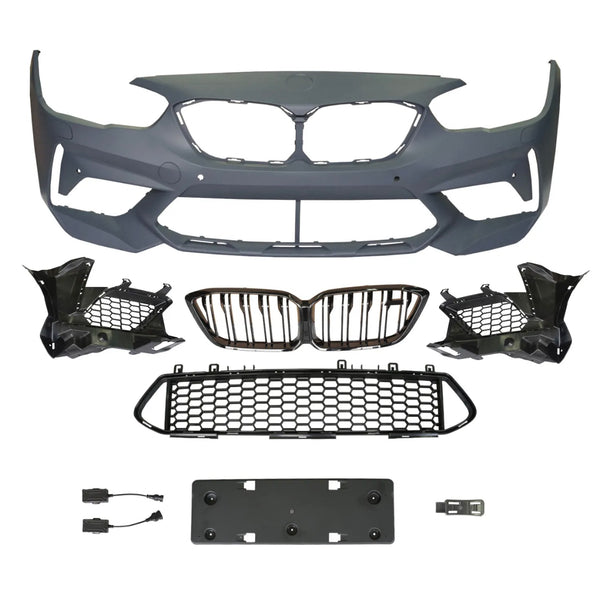 A collection of automotive parts includes a bumper cover, radiator grilles, and mounting brackets arranged on a plain background, suggesting components for vehicle front-end assembly.