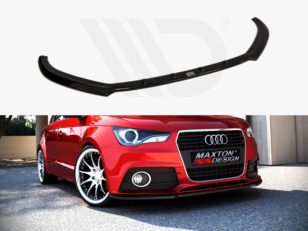 A black car front lip spoiler hovers above a parked red Audi car. The vehicle's grille displays "MAXTON DESIGN," surrounded by a sunny, outdoor environment.