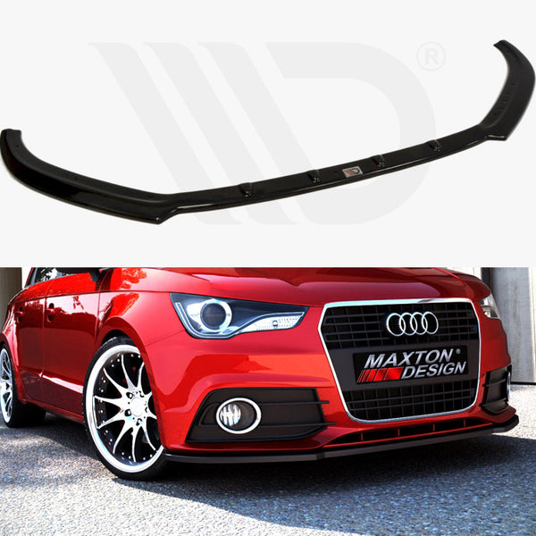 A black car front lip spoiler hovers above a parked red Audi car. The vehicle's grille displays "MAXTON DESIGN," surrounded by a sunny, outdoor environment.