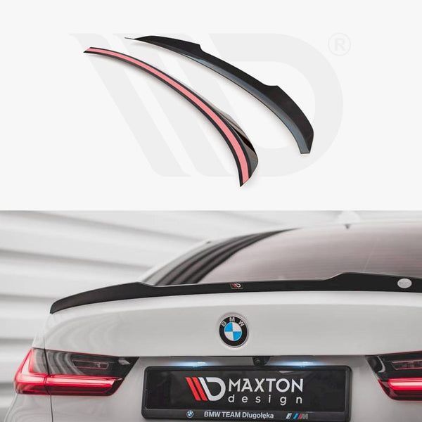 Spoiler displayed above; a black, aerodynamic car spoiler is installed on a white BMW's trunk, with glowing red rear lights. Text reads: “MAXTON design, BMW TEAM Długołęka.”