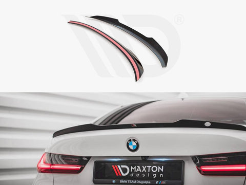 Spoiler displayed above; a black, aerodynamic car spoiler is installed on a white BMW's trunk, with glowing red rear lights. Text reads: “MAXTON design, BMW TEAM Długołęka.”
