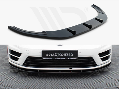 A black car front splitter is shown independently and installed on a white car's bumper. The white vehicle is parked on a patterned garage floor. License plate reads "#MAXTONIZED".