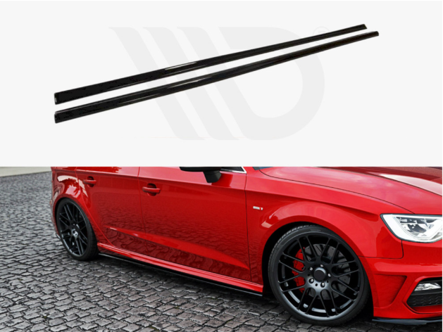 Two black side skirts are positioned above a red car, which features black wheels and is parked on cobblestone pavement. The setting suggests automotive modification.