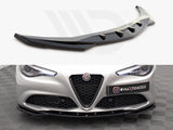 Front splitter displayed above a luxury car bumper installed below headlights and grille, on checkered floor. Text: 