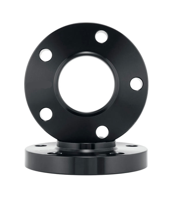 A black metal flange with five evenly spaced bolt holes rests vertically against another similar flange on a white background.