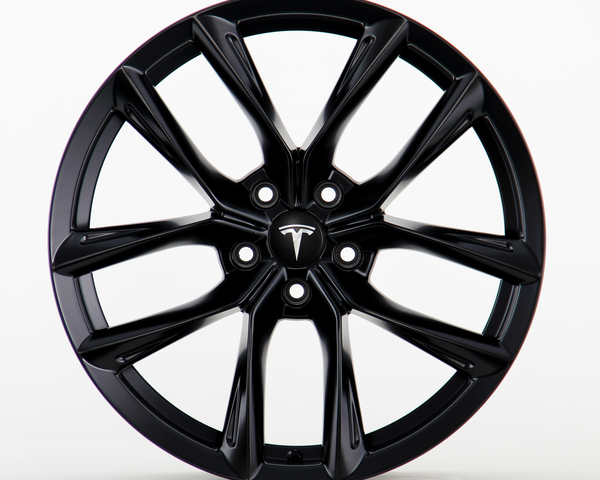 A black Tesla wheel rim with a sleek, multi-spoke design is shown in a clean, white studio setting. The central hub cap features the Tesla logo prominently.