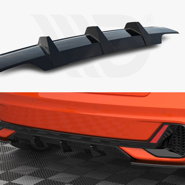 A black car rear diffuser shown separately and installed on an orange car's lower back bumper, displayed on a patterned garage floor, emphasizing aerodynamic style enhancements.