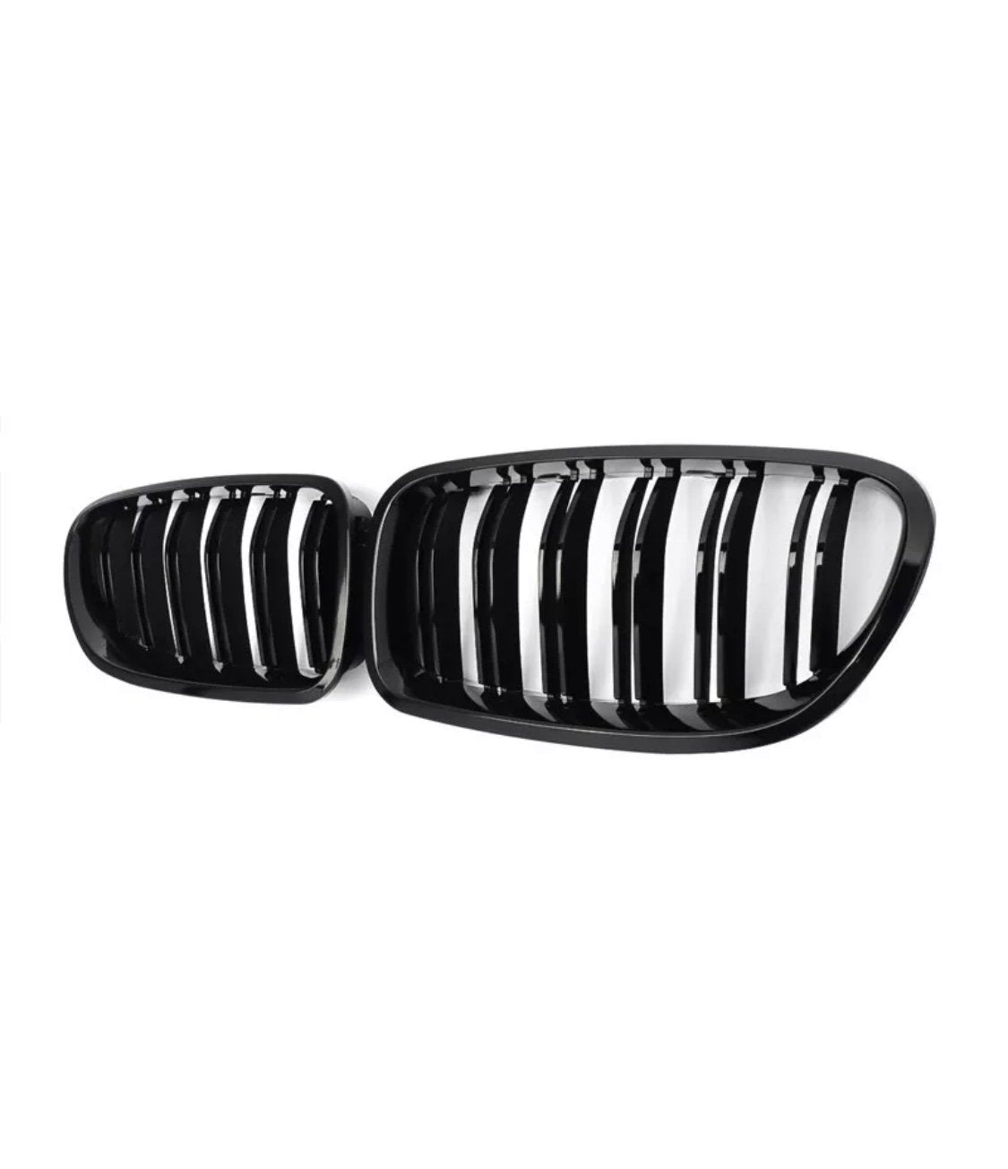 A pair of black car grilles with vertical slats, positioned side by side, set against a plain white background.