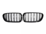 Two black car grilles with vertical slats are positioned side by side against a white background, suggesting automotive design components.