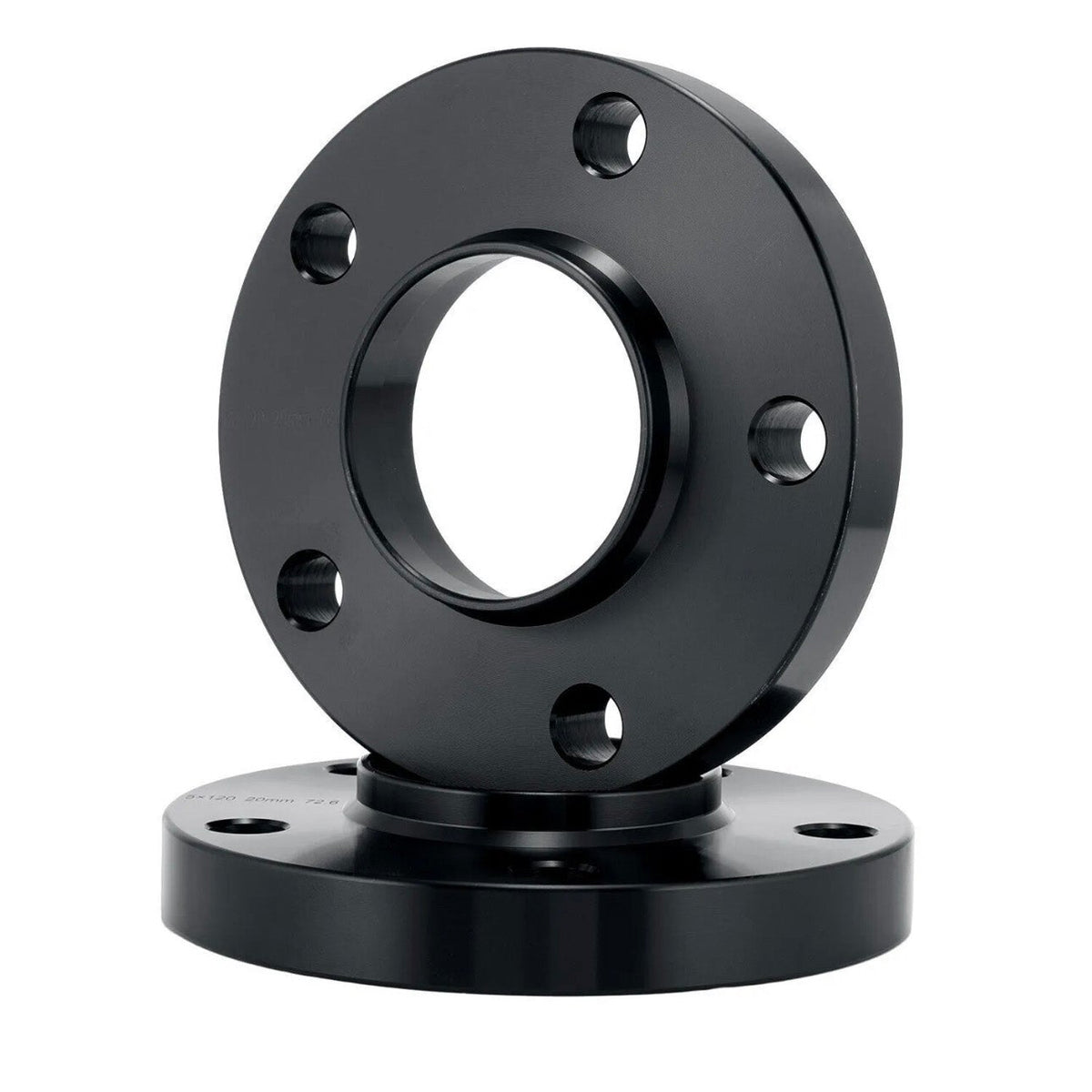 A black metal flange with multiple bolt holes rests on another flange against a plain white background, suggesting an industrial or mechanical setting.
