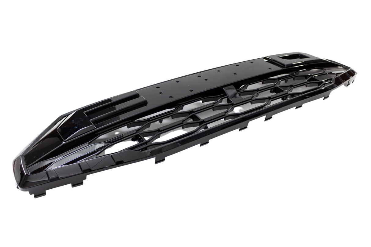 Black plastic car grille with a glossy finish, featuring an intricate pattern of openings, on a plain white background.