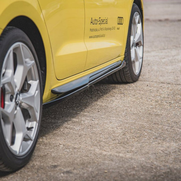 A yellow car's side with silver alloy wheels is parked on concrete. Text reads: "Auto-Special, Modifizierte, Neu Profi & Ausführung, 23617 Audi, www.auto-special-audi.de." The environment is open space.