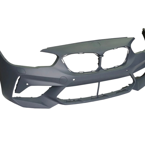 Gray car bumper, featuring grille cutouts and holes for mounting, is displayed against a plain white background. The bumper's design suggests it is intended for a sporty vehicle.