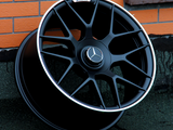 A black alloy wheel with the Mercedes-Benz logo and 