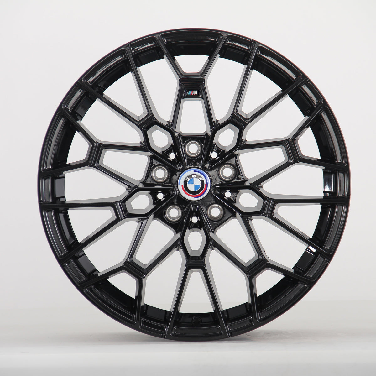 A glossy black, intricately designed car wheel with a central BMW logo and "M" insignia, set against a plain white background.