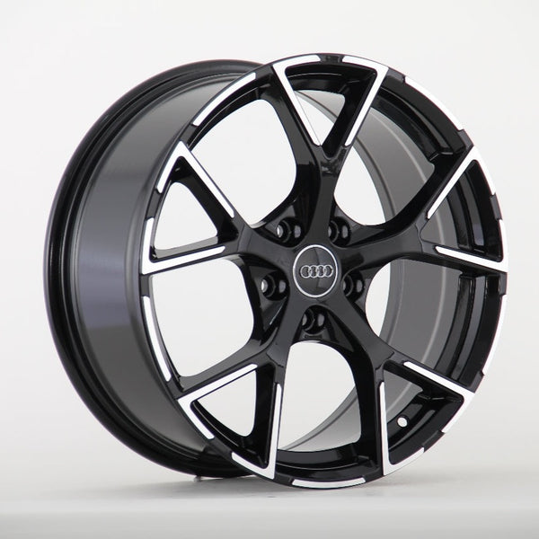 A glossy black alloy wheel with a five-spoke pattern, featuring the Audi logo at the center, displayed against a plain white background.