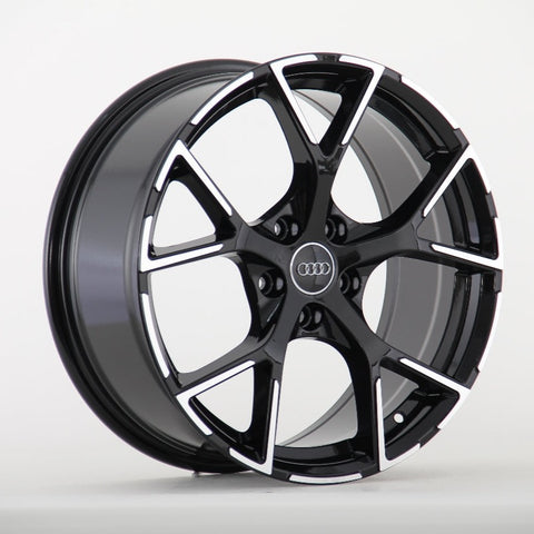 A glossy black alloy wheel with a five-spoke pattern, featuring the Audi logo at the center, displayed against a plain white background.