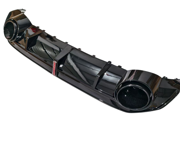 A glossy black car bumper features two circular exhaust outlets and ribbed design details. It is photographed against a plain white background, showcasing its sleek and reflective surface.