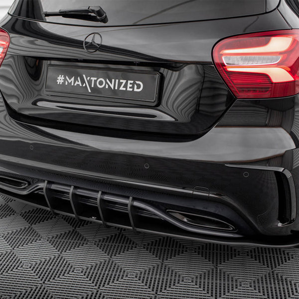 A black car's rear with illuminated tail lights is parked on a patterned surface. The license plate reads "#MAXTONIZED," and the setting appears to be indoors with reflected lights.